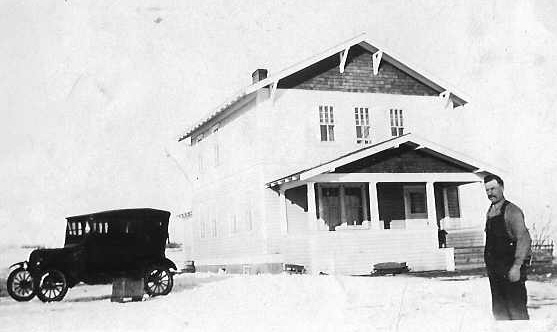 Grandpa Bedier standing in front of house
          1920